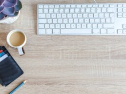 keyboard with coffee mug and pursue