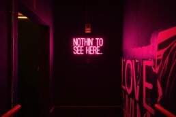 nothing to see here red neon light inside a house