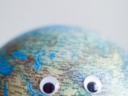 world map ball with eyes