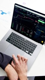 guy checking crypto exchange on laptop