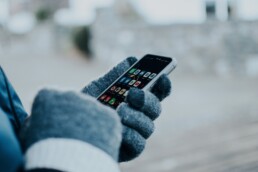 girl using phone in winter weather