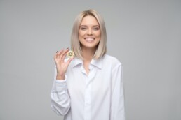 blonde girl with bitcoin physical coin