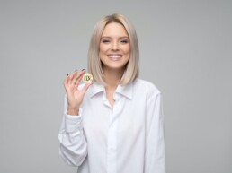 blonde girl with bitcoin physical coin