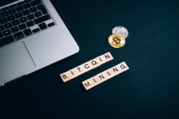 bitcoin and mining lettering with physical coin and glasses