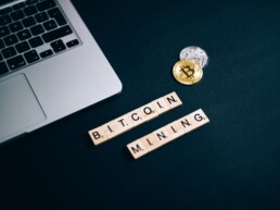 bitcoin and mining lettering with physical coin and glasses