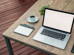 laptop, notepad and coffee on wooden table ready for working