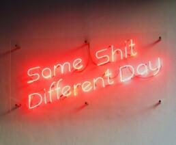 same shit different day neon insigna on the wall