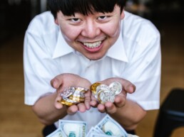happy asian guy with a lot of coin and money