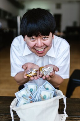 happy asian guy with a lot of coin and money
