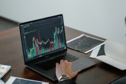 guy checking stock market on laptop