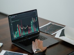 guy checking stock market on laptop