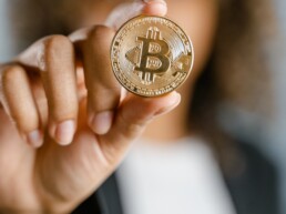 bitcoin physical coin holds by girl