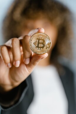 bitcoin physical coin holds by girl